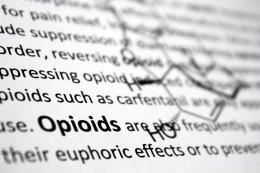 Book page with text and the word 'Opioids' in bold and part of a chemical structure