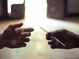 Hands holding a syringe